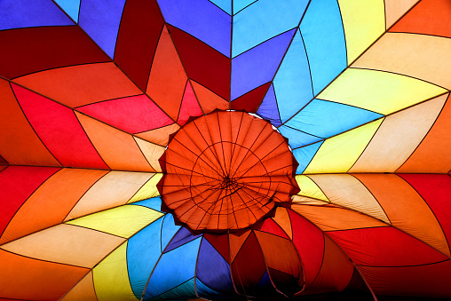 Background image of canvas and design of the inside of a hot air balloon.  Geogmetric pattern in yellow, red, orange and blue.