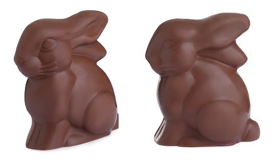 Delicious chocolate Easter bunnies on white background