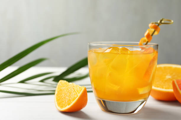 istock Delicious orange soda water on white table 1461675576