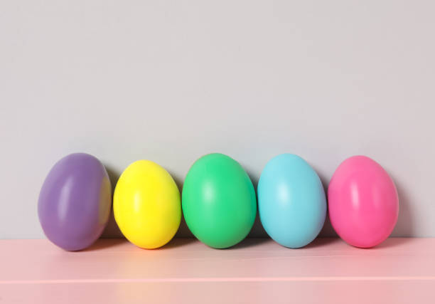 istock Easter eggs on pink wooden table against light grey background, space for text 1461675936