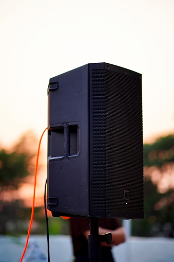 Acoustic sound speakers in sunset on nature background