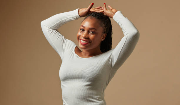 istock Young black woman smiling with hands above head. 1461677574