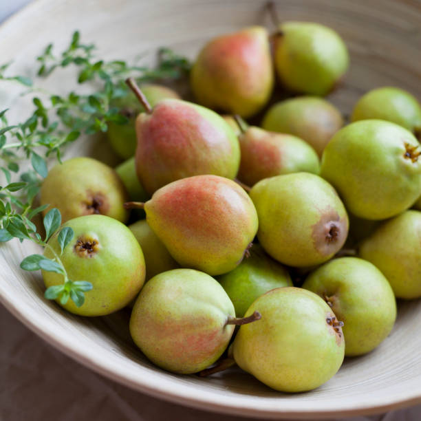 istock Delicious organic pear fruit on the kitchen worktop. Natural wooden background. 1461677694