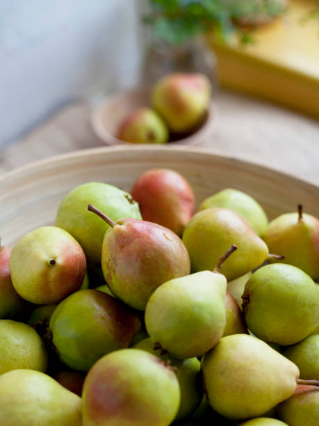 istock Delicious organic pear fruit on the kitchen worktop. Natural wooden background. 1461677767