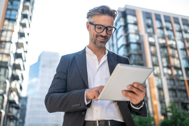 istock A businessman with a tablet in hands looking busy 1461678073