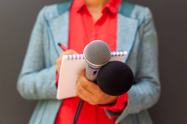 journaliste aux médias lors d’une conférence de presse, écrivant des notes, tenant un microphone - journalist photos et images de collection