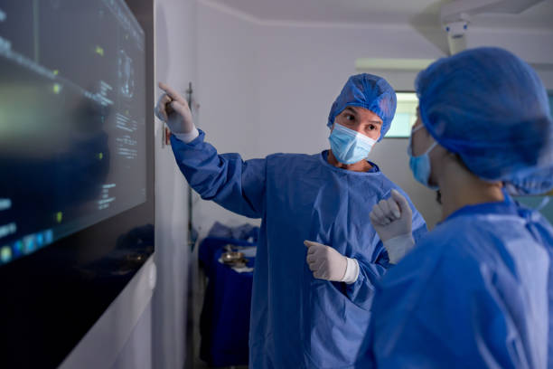istock Surgeons discussing a CAT scan in the operating room 1461681607