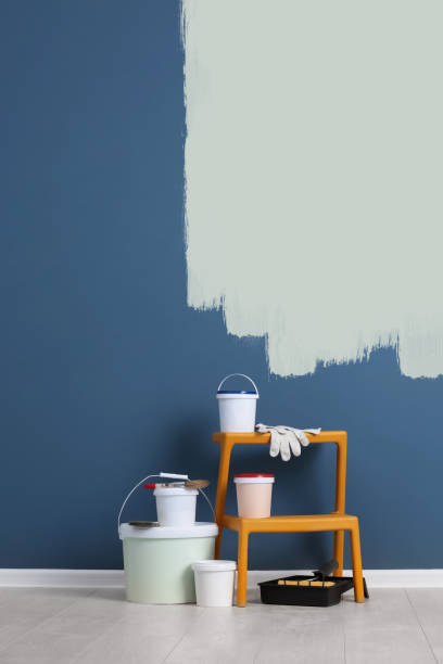 istock Set with decorator tools and paint on floor near color wall 1461683101