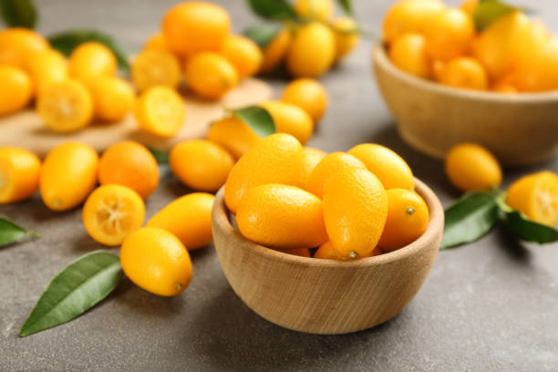 istock Fresh ripe kumquats in bowl on grey table 1461683315