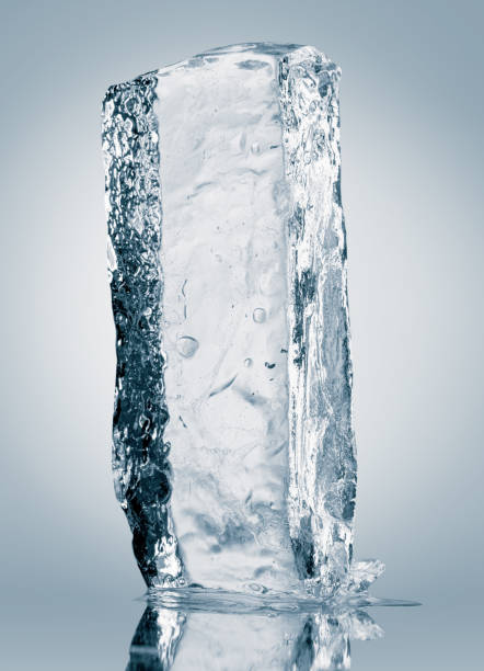 istock Crystal clear natural ice block in light blue tones on a white reflective surface. 1461684954