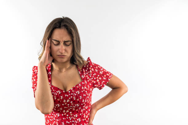 istock Young girl suffering from headache holding head with hands isolated over white background. 1461685641