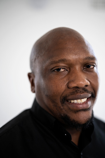 Portrait man with shaved head and black shirt