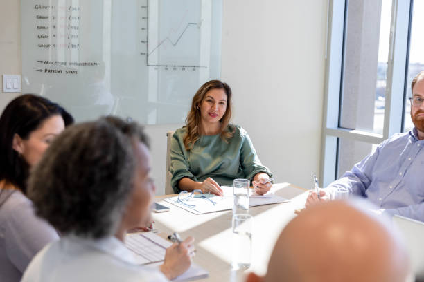 istock Diverse staff listen to unrecognizable woman's contribution to meeting 1461688278