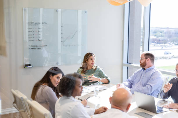 istock High angle view diverse hospital staff meeting in conference room 1461688452