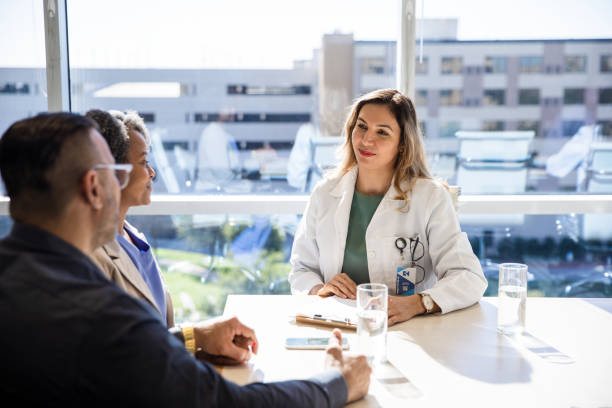istock Husband supports wife during medical appointment 1461688521