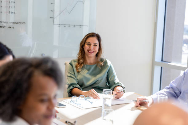 istock Female team lead smiling at her colleagues 1461688648