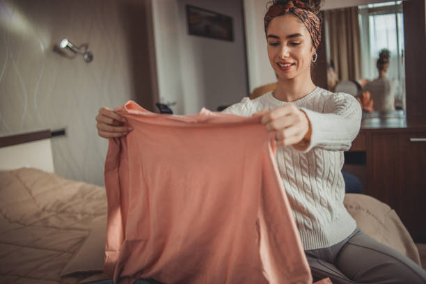 istock A couple in a hotel room, unpacking things from a suitcase. 1461688943