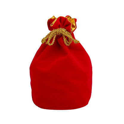 Red gift velvet pouch tied with gold rope, isolated on white background, close-up
