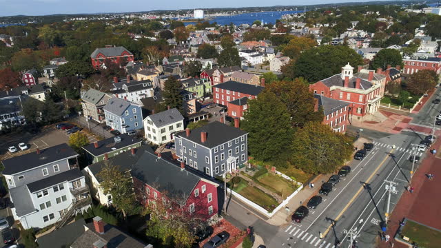 Derby Street of Salem, Massachusetts, on an autumn day, with a distant view of the North River. Aerial video with the backward-panning camera motion.