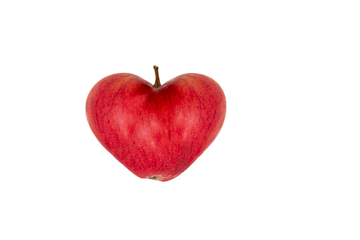 Red apple in the shape of a heart, isolated on a white background