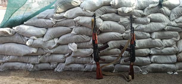 istock Two Kalashnikovs standing near sandbagged fortifications. AK-74 outdoor 1461704122