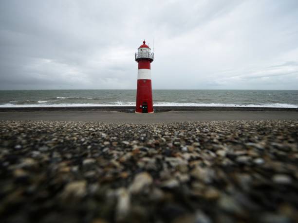 Panorama view of red white striped lighthouse tower Vuurtoren Noorderhoofd in Westkapelle Zeeland Netherlands North Sea stock photo
