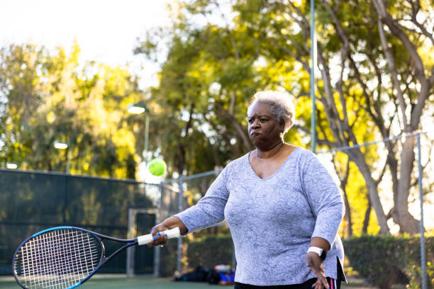 istock Senior Black Woman Playing Tennis 1461718832