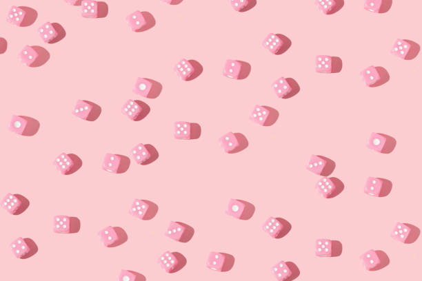 istock Romantic creative pattern with baby pink dices on pastel pink background. 80s or 90s retro fashion aesthetic love concept. Minimal romantic idea. 1461731096