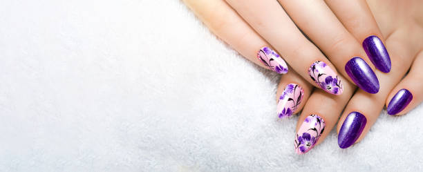 istock Dark blue flower manicure on long, sharp nails closes up on a white background. Gel nails. 1461736582
