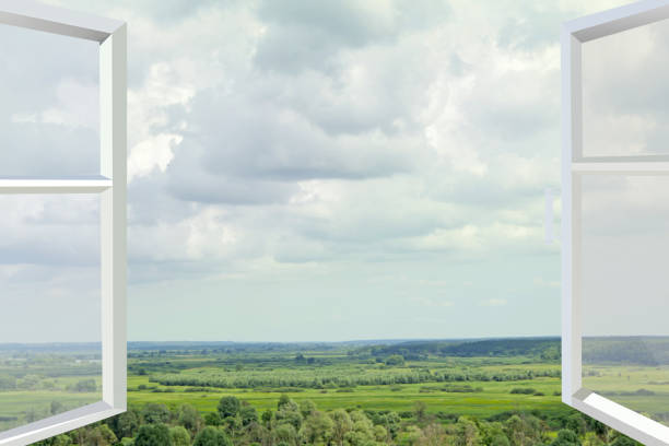 Opened window to summer field. Panorama from opened window. Nature behind window. Panoramic window overlooking beautiful natural landscape.Natural scenery from bedroom window. Beautiful view from room