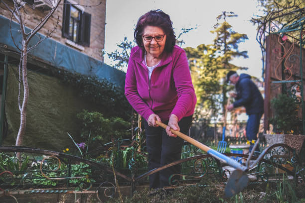 istock Grandmother is happy about flowers blooming 1461746437