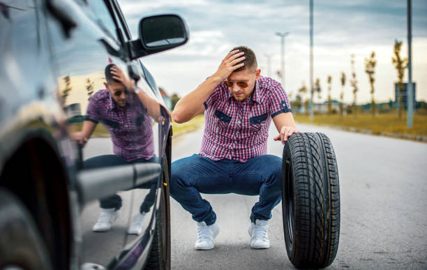 istock Driver changing wheel on the vehicle. Transportation, traveling concept 1461760332