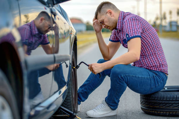 istock Driver changing wheel on the vehicle. Transportation, traveling concept 1461760896