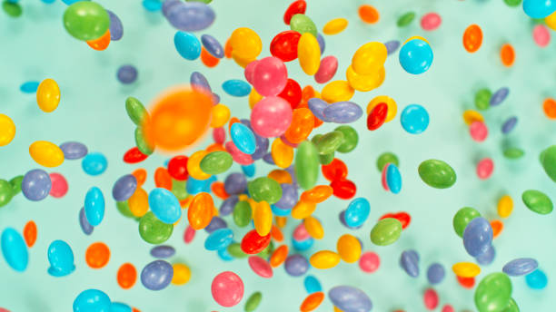 Sweet candies flying, freeze motion against pastel background