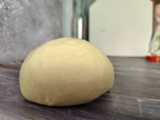 istock Raw dough ball on a wooden table 1461761598