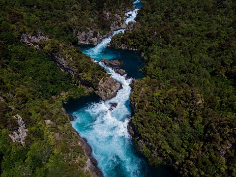 Aerial panorama of water flooded canyon Waikato river rapids surrounded by green nature forest at Aratiatia Dam near Lake Taupo North Island New Zealand