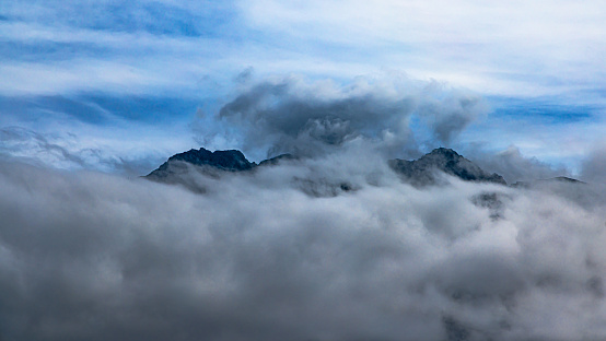 Alps showing its grandeur even when surrounded by dense mist, fog, and clouds