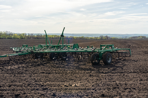 Seedbed cultivator on a field on a spring morning.