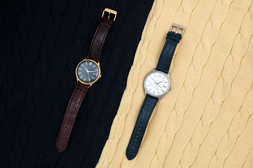 Wristwatches placed on textured wool background