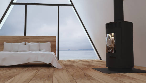 istock Minimalistic interior of a small contemporary hut with fireplace and bed. Full wall window 1461784712