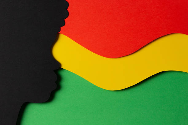 istock Black History Month color background. African Americans history celebration. Abstract geometric red, yellow, green color background with black paper cut people silhouette. Top view 1461787640