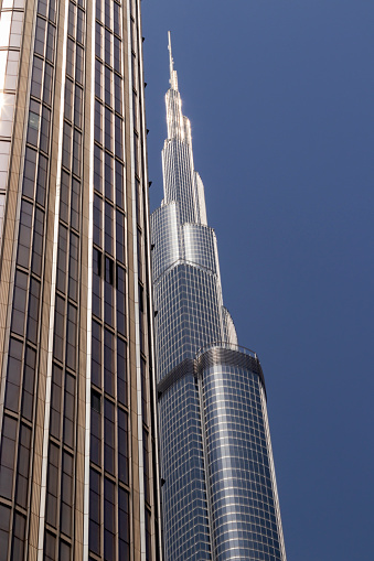 Office building with Burj Khalifa tower behind it, in Dubai
