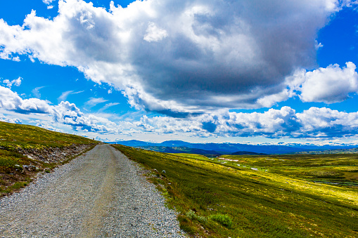 Beautiful mountain and landscape panorama with untouched nature rivers lakes rocks stones and trekking path trail way road in Rondane National Park Ringbu Innlandet Norway in Scandinavia.