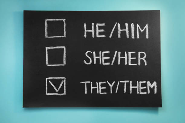 istock Blackboard with written pronouns on turquoise background, top view. Gender equality 1461793838