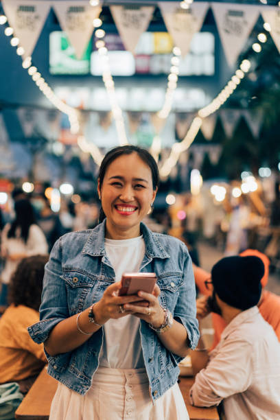 istock A Happy Beautiful Businesswoman Using Her Mobile Phone While Looking At Camera 1461794235