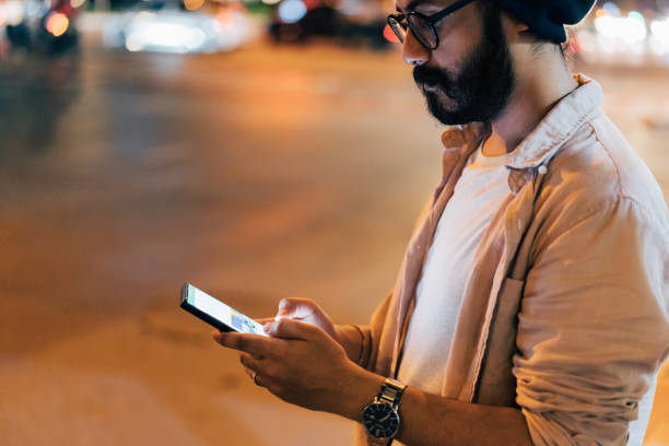 istock A Serious Businessman Using His Mobile Phone While Standing On The Street At Night 1461794251