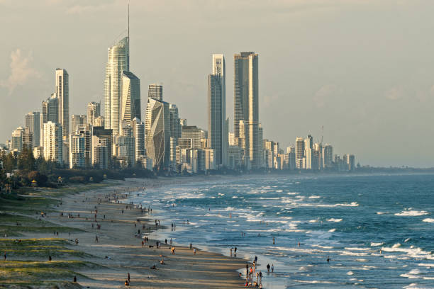 Landscape of Gold Coast, city next to Brisbane in Australia, evening or morning sun on the beach, blue ocean with waves and skyscrapers. Australian holidays in summer stock photo