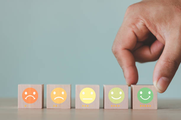 istock The best excellent business services rating customer experience concept. client's hand picked the happy face smile face icon and five star symbol on wooden cube block. 5 Star Satisfaction. 1461794959