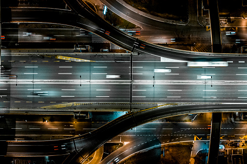Highway loop seen during the night with all the lights and captured with a drone from a different perspective directly upside down.
