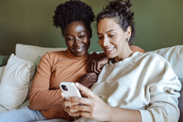 istock Two young women use smart phones at home 1461798385